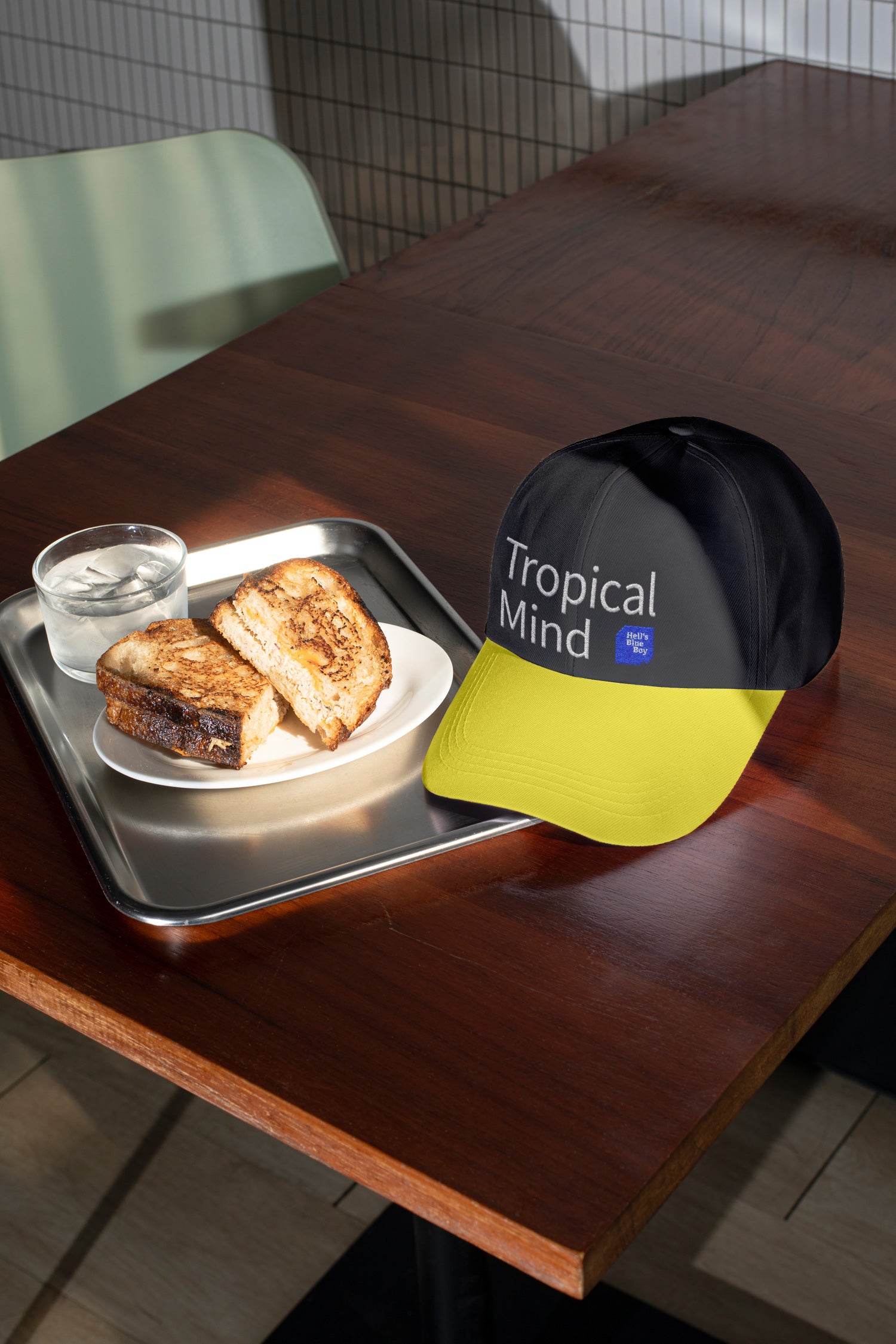 Baseball cap mockup placed on a café table with sandwich.