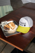 Baseball cap mockup placed on a café table with sandwich.