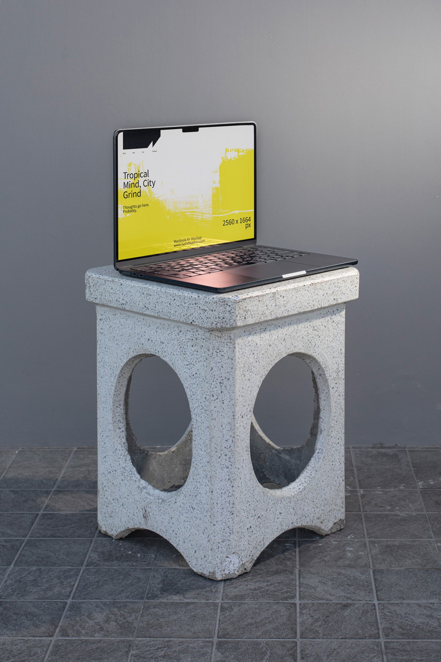 Photorealistic MacBook mockup placed on a concrete bench.