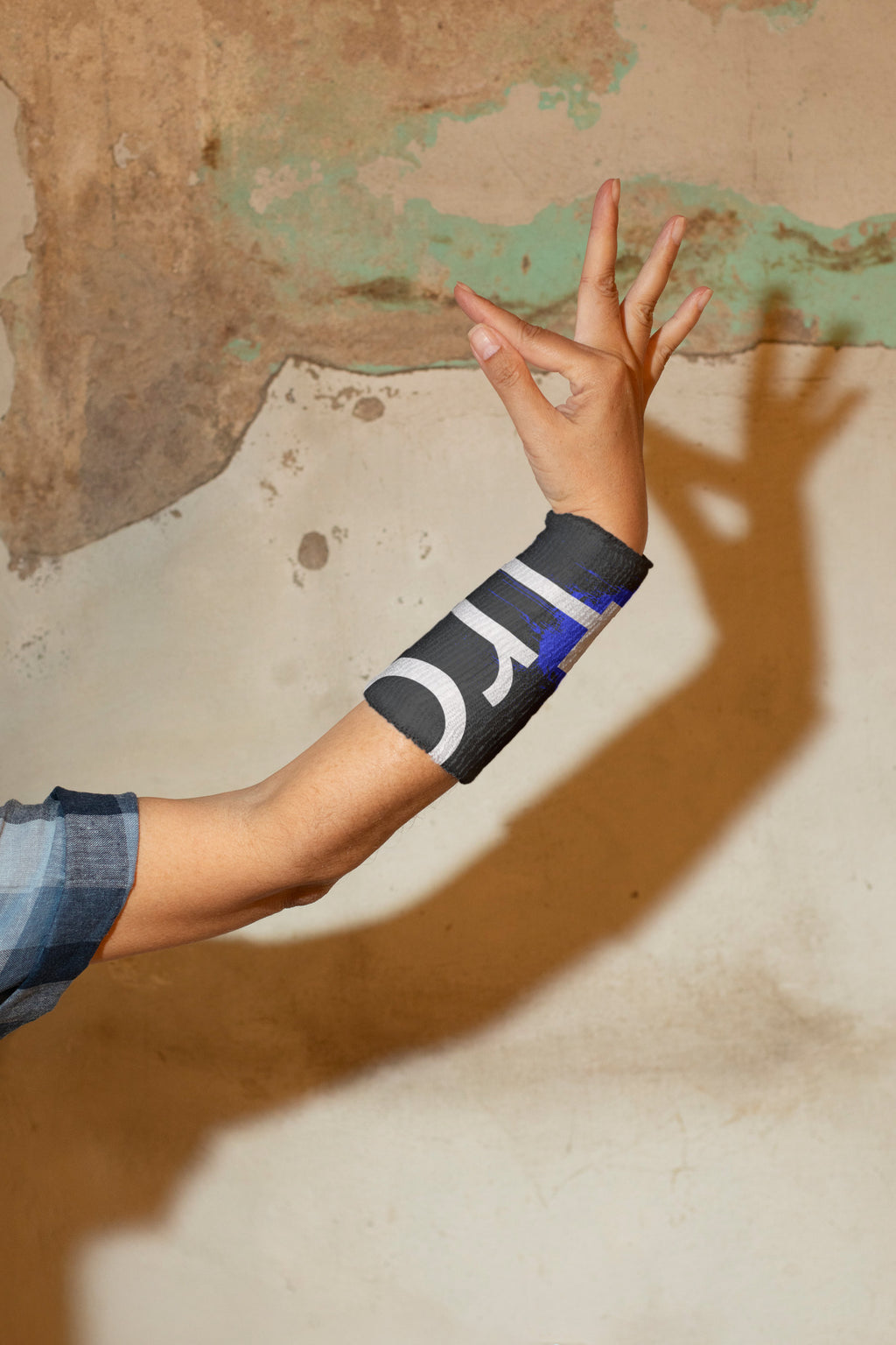 Female hand in classical Thai Khon dance gesture wearing a wrist sweatband.