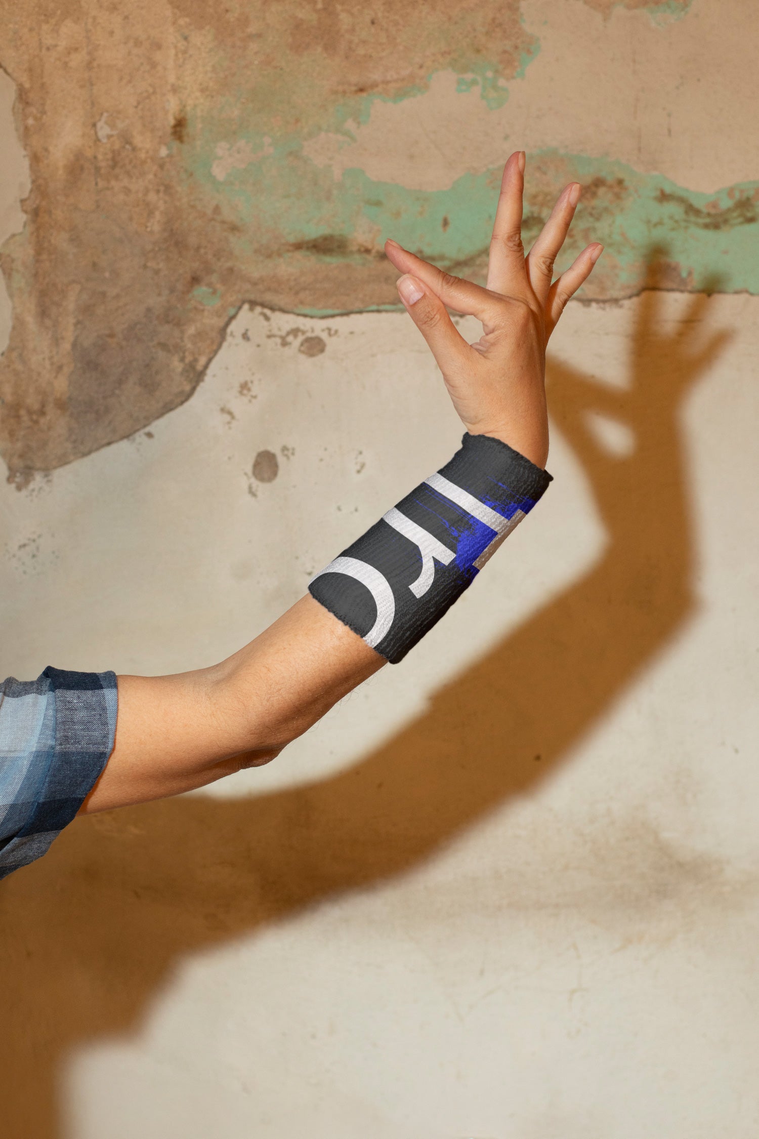 Female hand in classical Thai Khon dance gesture wearing a wrist sweatband.