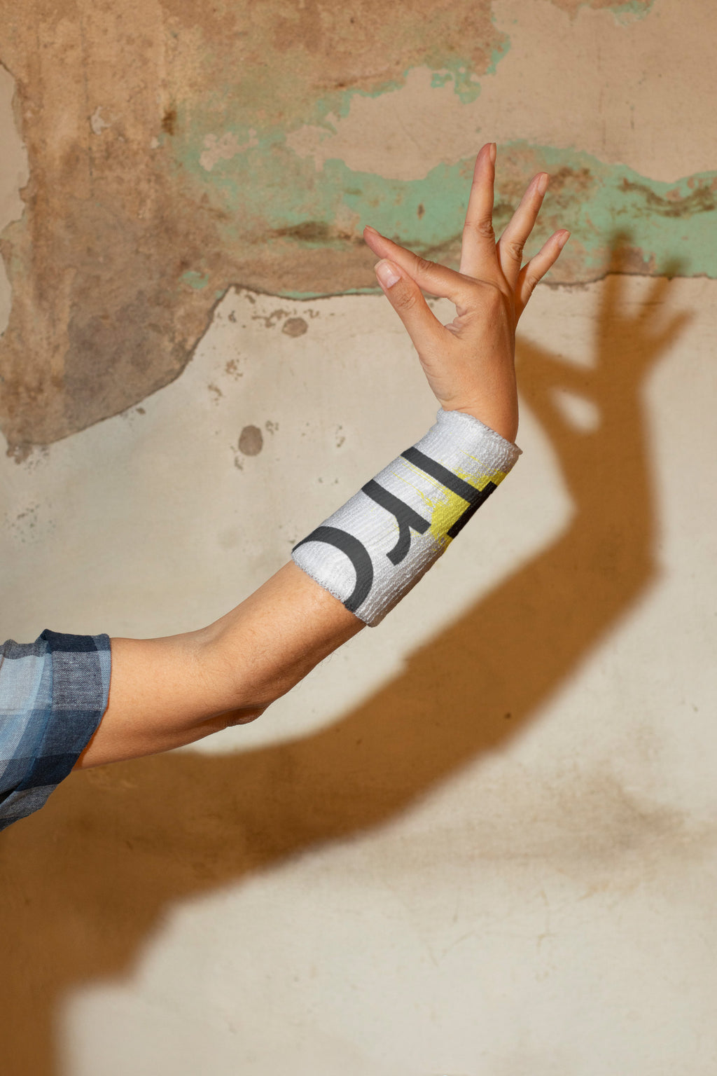 Female hand in classical Thai Khon dance gesture wearing a wrist sweatband.